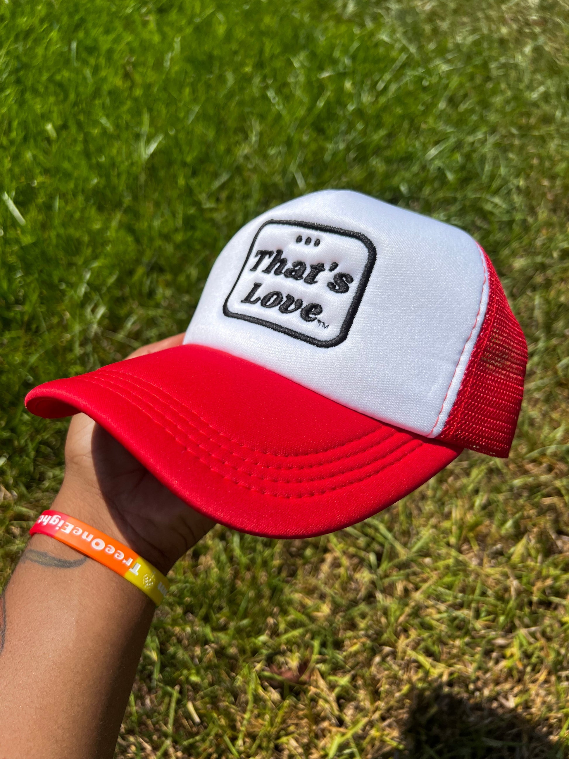 Red and White Foam Trucker Hat. Bold "Thats Love" in Bold Black font