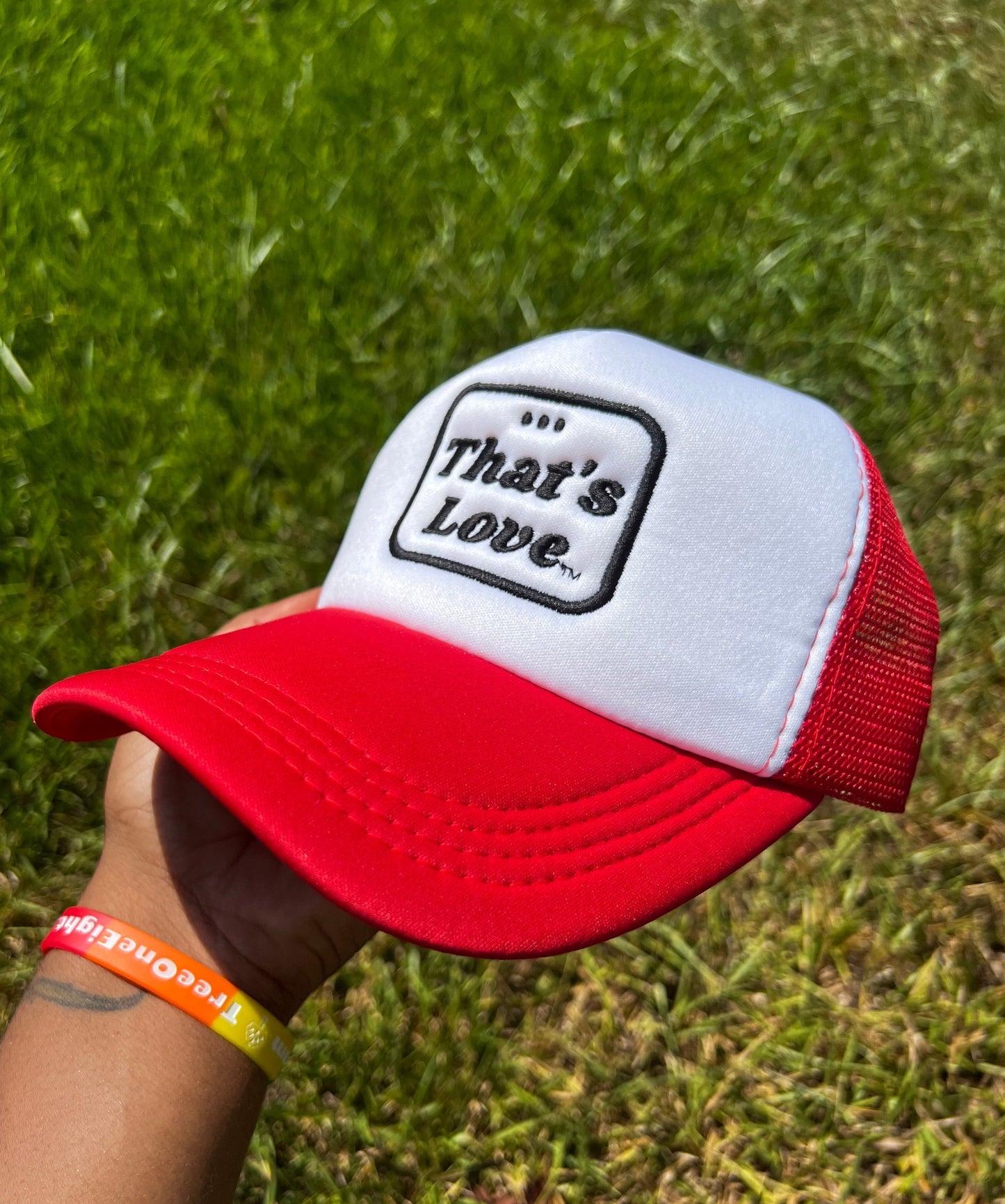 Red and White Foam Trucker Hat. Bold "Thats Love" in Bold Black font